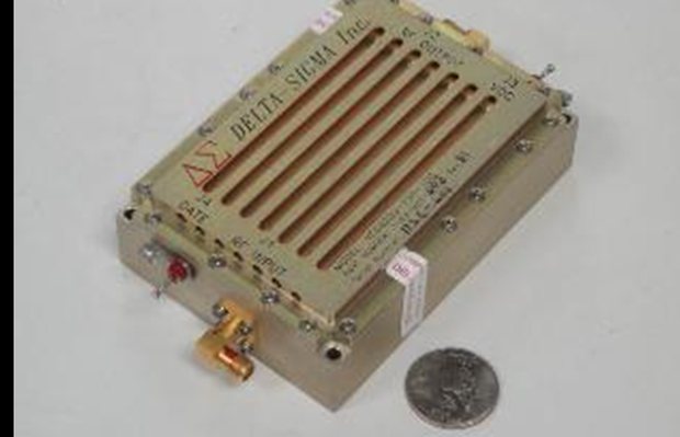 One kilowatt HF amplifier module beside a coin for scale